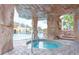 Relaxing hot tub nestled under a rock grotto at 8951 Bismarck Palm Rd, Kissimmee, FL 34747