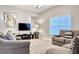 Spacious living room featuring comfortable seating and a large TV at 8951 Bismarck Palm Rd, Kissimmee, FL 34747