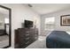 Bedroom with TV, dresser, and full-size bed at 8951 Bismarck Palm Rd, Kissimmee, FL 34747