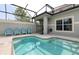 Private screened-in pool with patio furniture and grill at 8951 Bismarck Palm Rd, Kissimmee, FL 34747