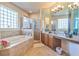 Elegant bathroom featuring a large bathtub, shower, and granite vanity at 20606 Quinn St, Orlando, FL 32833