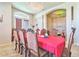 Formal dining room with a large table, chandelier, and red tablecloth at 20606 Quinn St, Orlando, FL 32833