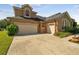 Front view of two-story house with driveway and landscaping at 20606 Quinn St, Orlando, FL 32833