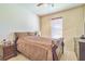 Bedroom with sleigh bed, nightstand, dresser, and window blinds at 20606 Quinn St, Orlando, FL 32833