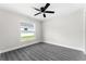 Bright bedroom with wood-look floors and ceiling fan at 43 S Kentucky Ave, Umatilla, FL 32784