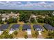 Community of new construction homes with gray roofs and white garage doors at 43 S Kentucky Ave, Umatilla, FL 32784