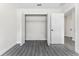 Bedroom with double door closet and wood-look floors at 43 S Kentucky Ave, Umatilla, FL 32784