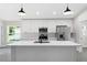 Modern kitchen with white cabinets, stainless steel appliances, and island at 43 S Kentucky Ave, Umatilla, FL 32784