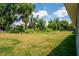 Spacious backyard with grassy area and mature trees at 43 S Kentucky Ave, Umatilla, FL 32784