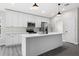 Modern kitchen with white cabinets, stainless steel appliances, and island at 43 S Kentucky Ave, Umatilla, FL 32784