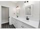 Double vanity bathroom with white cabinets and modern lighting at 43 S Kentucky Ave, Umatilla, FL 32784