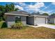 Newly built gray house with a two-car garage and landscaping at 43 S Kentucky Ave, Umatilla, FL 32784