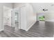 Bright hallway with grey flooring and access to bedrooms and bath at 43 S Kentucky Ave, Umatilla, FL 32784