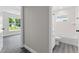 Bathroom with tub, toilet, and wood-look floors at 43 S Kentucky Ave, Umatilla, FL 32784