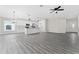Open kitchen with white cabinets, stainless steel appliances, and a large island at 43 S Kentucky Ave, Umatilla, FL 32784