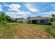 Large backyard with grassy area and mature trees at 43 S Kentucky Ave, Umatilla, FL 32784
