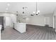 Open concept kitchen with island, stainless steel appliances, and white shaker cabinets at 43 S Kentucky Ave, Umatilla, FL 32784