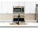 Modern kitchen with white cabinets, stainless steel appliances, and a sink at 43 S Kentucky Ave, Umatilla, FL 32784