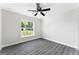 Bright bedroom with wood-look floors and ceiling fan at 43 S Kentucky Ave, Umatilla, FL 32784