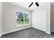 Bright bedroom with large window, ceiling fan, and double door closet at 43 S Kentucky Ave, Umatilla, FL 32784
