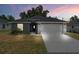 Modern two-car garage home with stone accents at 43 S Kentucky Ave, Umatilla, FL 32784