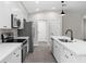 Modern kitchen with white cabinets and stainless steel appliances at 43 S Kentucky Ave, Umatilla, FL 32784