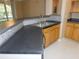 Kitchen features a double sink and dark countertops at 3480 Soho St # 101, Orlando, FL 32835