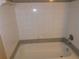 Bathroom with shower/tub and tiled walls at 3480 Soho St # 101, Orlando, FL 32835