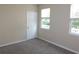 Bedroom with two windows and a door at 3480 Soho St # 101, Orlando, FL 32835