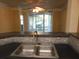 Kitchen sink and view into living room at 3480 Soho St # 101, Orlando, FL 32835