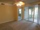 Living room with access to another room and balcony at 3480 Soho St # 101, Orlando, FL 32835