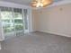 Living room with ceiling fan and sliding glass doors at 3480 Soho St # 101, Orlando, FL 32835