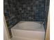 Bathroom with tub shower and dark tile at 3480 Soho St # 101, Orlando, FL 32835