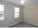 Bedroom with two windows and ceiling fan at 3480 Soho St # 101, Orlando, FL 32835