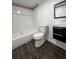 Clean bathroom with a bathtub, toilet, and floating vanity at 1526 Lakewood Rd, Davenport, FL 33837