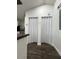 Hallway with bi-fold doors to utility closet at 1526 Lakewood Rd, Davenport, FL 33837