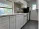 Modern kitchen with white cabinets and stainless steel sink at 1526 Lakewood Rd, Davenport, FL 33837