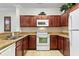 Modern kitchen with granite countertops and dark wood cabinets at 1370 Tuscan Terrace # 2205, Davenport, FL 33896
