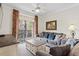 Spacious living room with grey sofas, a coffee table and sliding doors to a balcony at 1370 Tuscan Terrace # 2205, Davenport, FL 33896