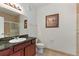 Bathroom with granite countertop, dark wood cabinets, and a toilet at 1370 Tuscan Terrace # 2205, Davenport, FL 33896