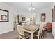 Elegant dining area with a farmhouse table and access to the living room at 1370 Tuscan Terrace # 2205, Davenport, FL 33896