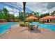 Resort-style pool with lounge chairs, patio tables, and umbrellas at 8020 Tuscany Way # 2205, Davenport, FL 33896