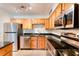 Modern kitchen with stainless steel appliances and wood cabinets at 320 Black Oak Ct # 107, Altamonte Springs, FL 32701