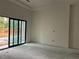 Spacious unfinished bedroom with large sliding glass doors at 3304 Harrison Ave, Orlando, FL 32804