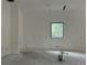 Unfinished bedroom with a large window and concrete floors at 3304 Harrison Ave, Orlando, FL 32804
