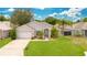 One-story home with a two-car garage and well-manicured lawn at 421 Paradise Woods Ct, Davenport, FL 33896