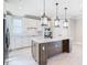 Modern kitchen with a large island, stainless steel appliances, and white cabinets at 4234 Sunset Preserve Blvd, Orlando, FL 32820