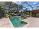 Screened pool and spa with a rock waterfall feature at 9227 Cypress Cove Dr, Orlando, FL 32819