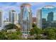 Aerial view of a high-rise building in a city setting with surrounding buildings and lush green spaces at 322 E Central Blvd # 710, Orlando, FL 32801