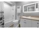 Clean bathroom with a bathtub, toilet, and vanity with a lighted mirror at 322 E Central Blvd # 710, Orlando, FL 32801